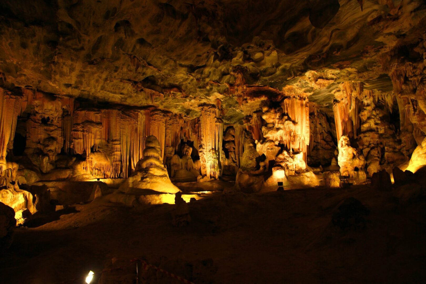 A cave with many pillars and lights on the ceiling