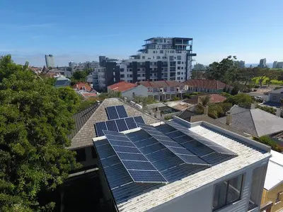 A view of a building with solar panels on the roof.